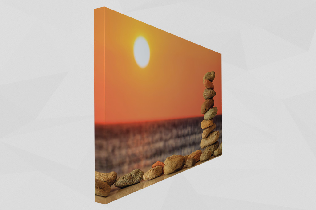 Acoustic picture soni PICTURE balanced stones showsA collection of stones on the beach, illuminated by the warm light of the sunset.